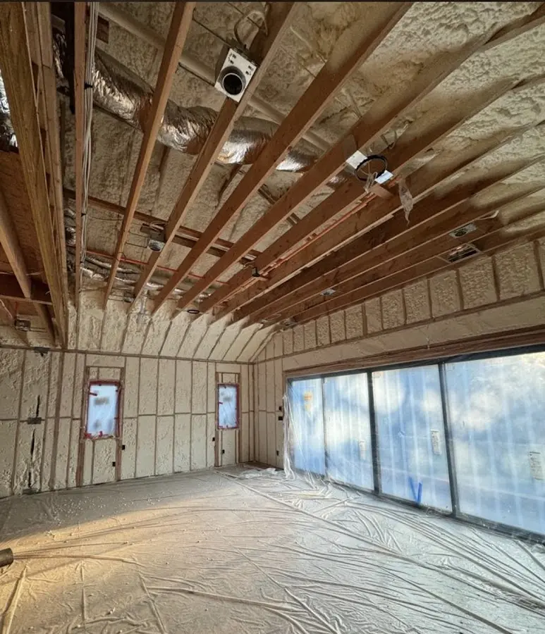 Interior walls and ceiling insulated with spray foam during new construction in Geneva